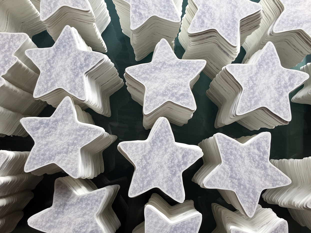 White Christmas stars made of Foamex piled up ready to be distributed to EAT Foodchain