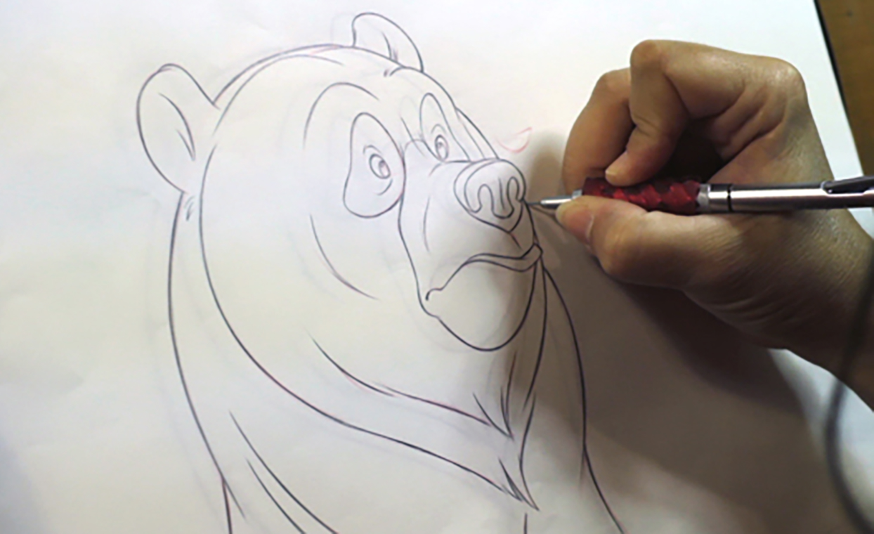 Disney artist Aaron Blaise hand drawing the Bear on paper in the John Lewis advert