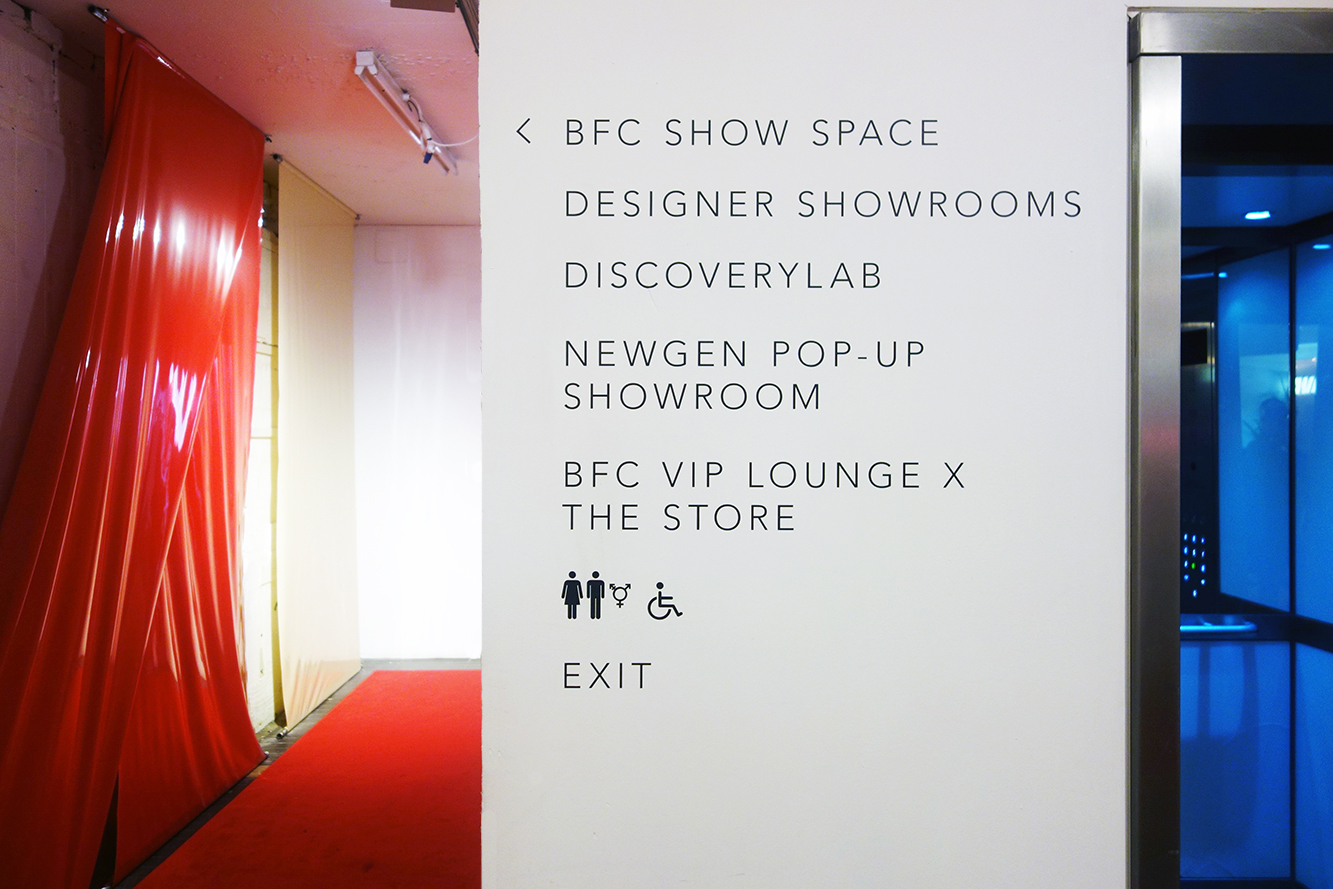 directional signs on the wall for London Fashion Week event in London