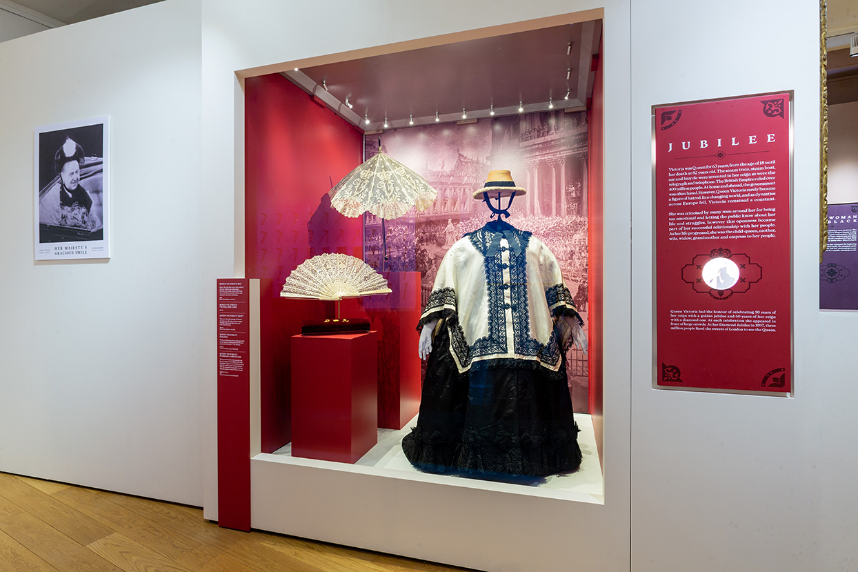 queen victoria's clothing on display at the woman & crown exhibition with descriptive signage