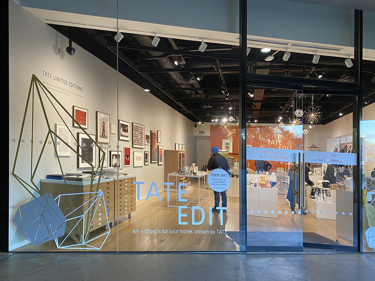 Large gold, silver & white geometric vinyl decals placed on the Tate Modern Shop windows