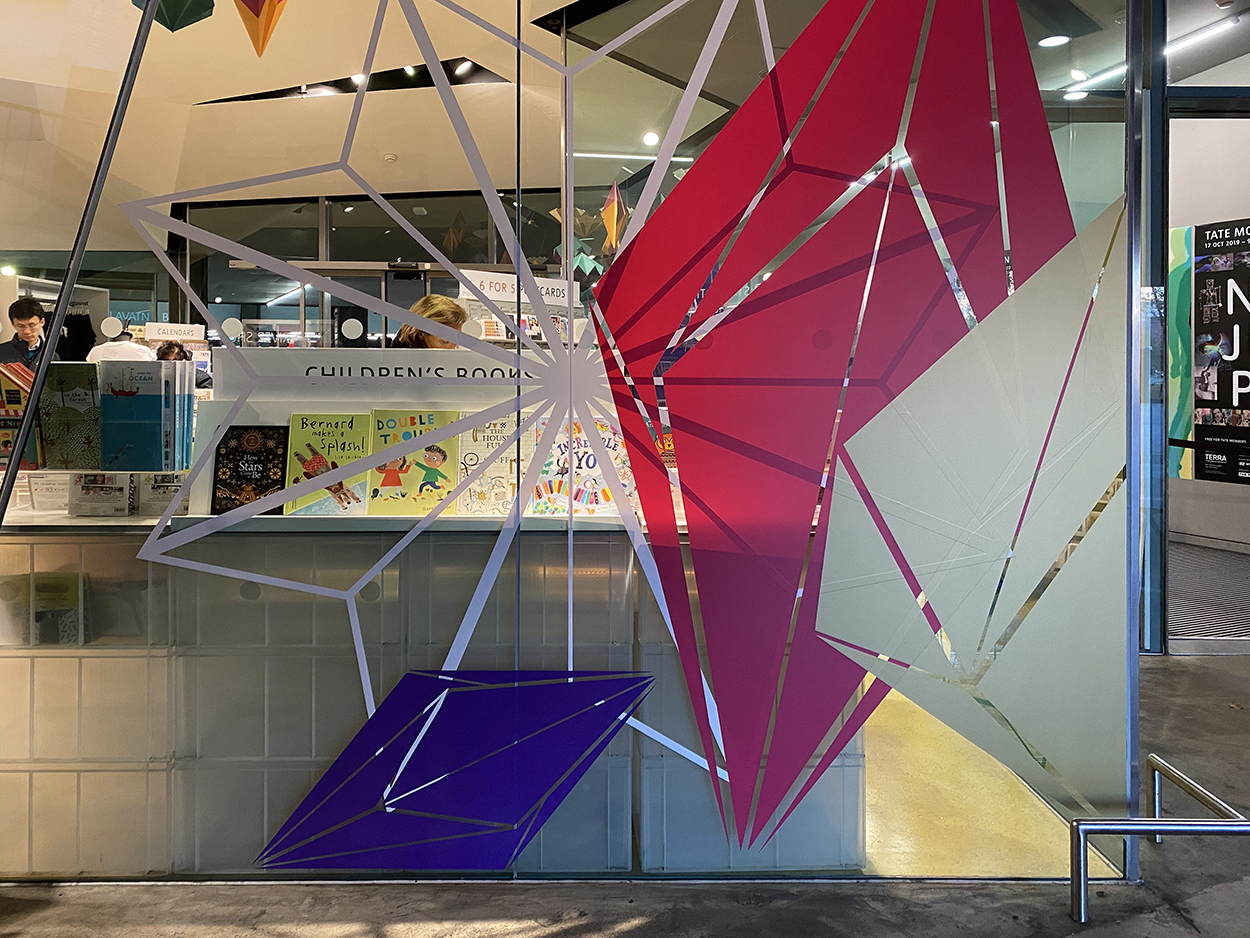 External view of the large vinyl decals placed onto glass windows at the Tate Modern shop