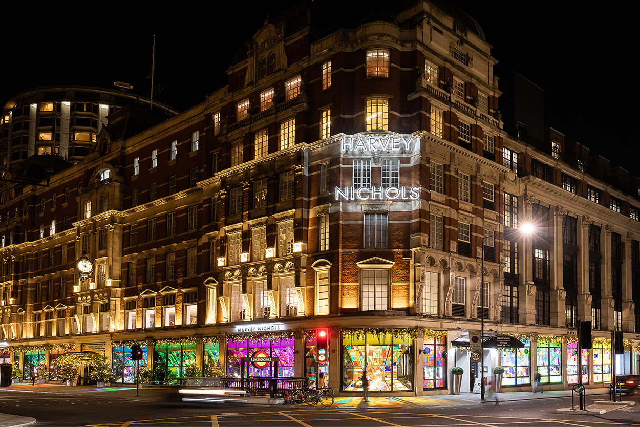 night-time scene of the outside of Harvey Nichols Christmas window display in London