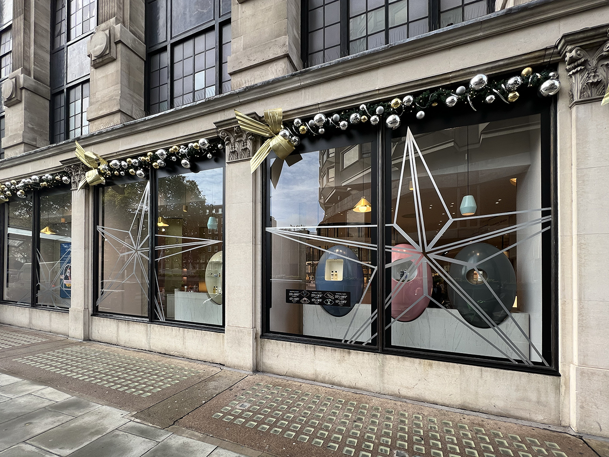 large silver star window decals for iconic retailer Harvey Nichols at Christmas