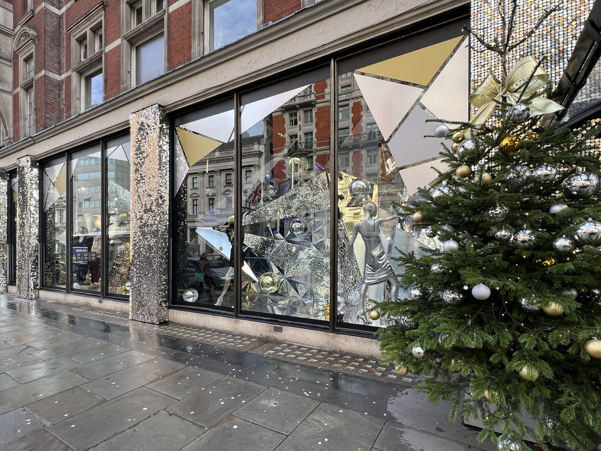 street view of Harvey Nichols large Christmas window display with metallic disco ball inspired