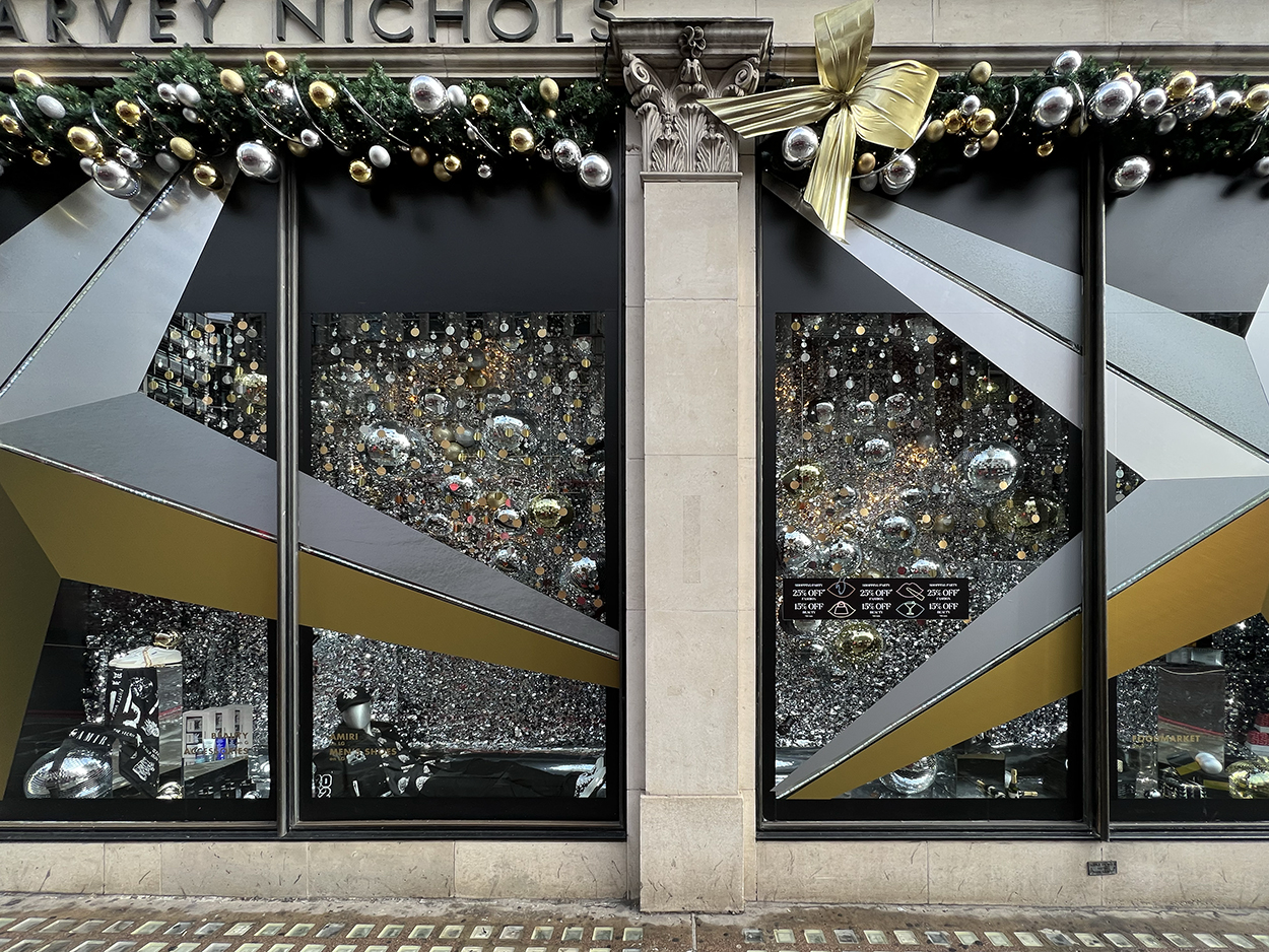large format gold & silver window decal stars displayed in Harvey Nichols Christmas display