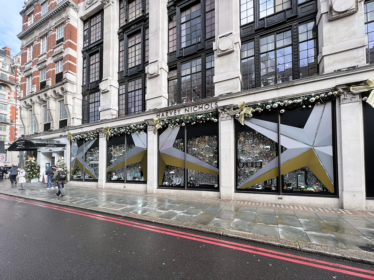 iconic retailer Harvey Nichols Christmas metallic window display featuring large window decals