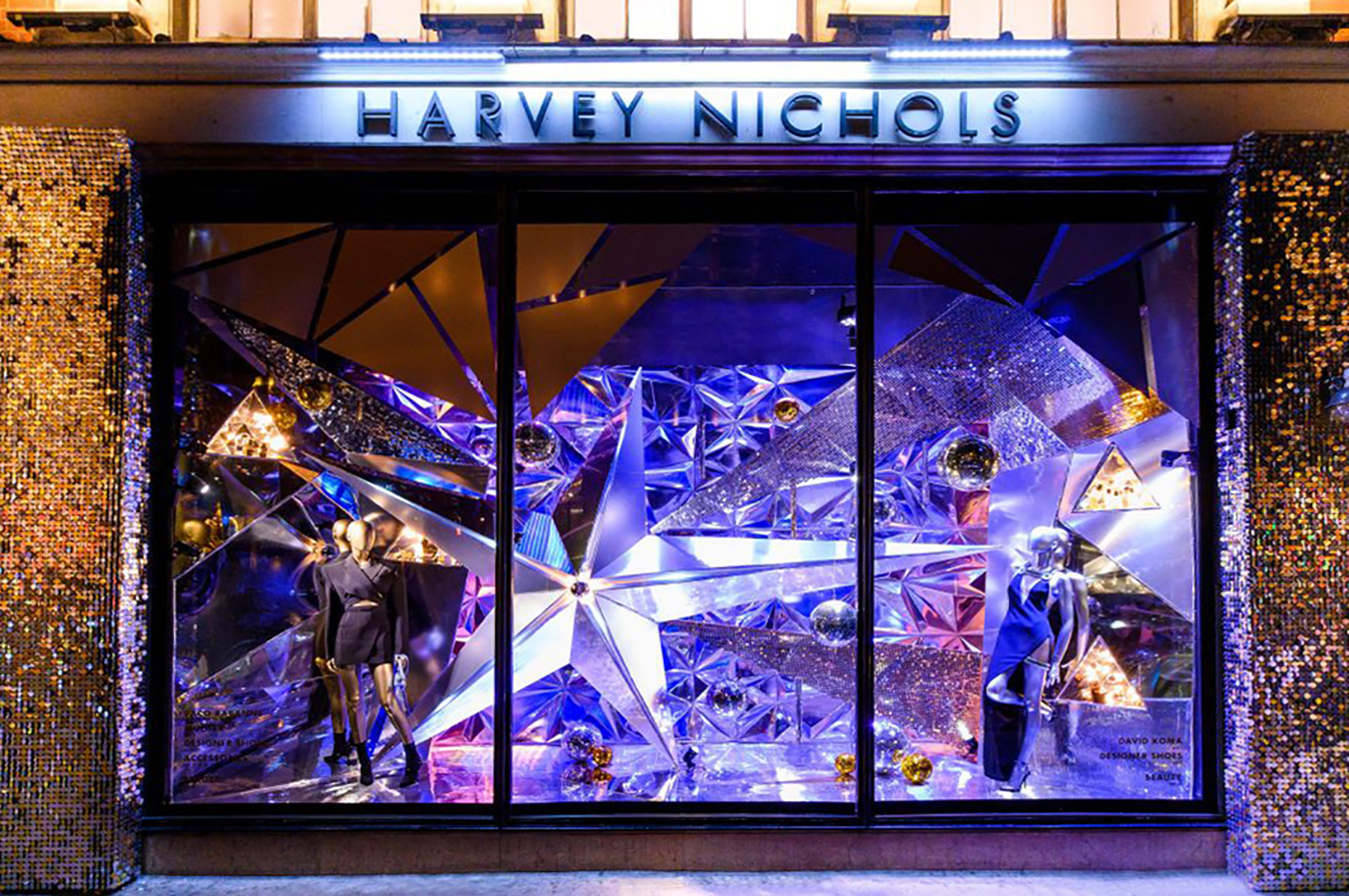 Harvey Nichols iconic Christmas window displays all lit up & sparkling at night time